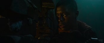 Movie still from “Without Remorse” (2021), directed by Stefano Sollima – A man is looking into the light in a dark room; Close Up shot, Low angle