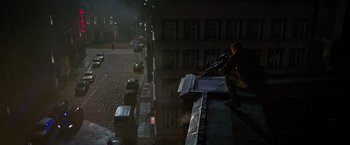 Movie still from “Without Remorse” (2021), directed by Stefano Sollima – A man on the roof of a building with a rifle; Extreme Wide shot, High angle