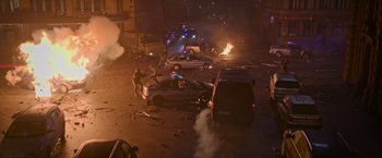 Movie still from “Without Remorse” (2021), directed by Stefano Sollima – A street scene with cars and a van on fire; Extreme Wide shot, High angle