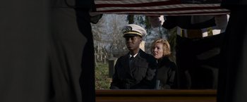 Movie still from “Without Remorse” (2021), directed by Stefano Sollima – A man in a uniform sitting next to a woman in a carriage; Medium shot, Over the shoulder angle