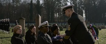 Movie still from “Without Remorse” (2021), directed by Stefano Sollima – A man in a military uniform standing in front of a group of people; Medium shot, High angle