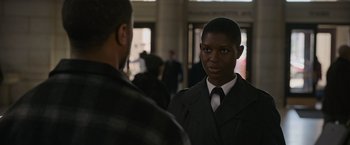 Movie still from “Without Remorse” (2021), directed by Stefano Sollima – A man in a suit and tie standing next to another man in a suit and tie; Close Up shot, Over the shoulder angle