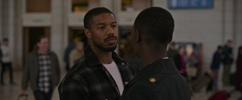 Movie still from “Without Remorse” (2021), directed by Stefano Sollima – Two men talking to each other in front of a crowd; Close Up shot, Over the shoulder angle