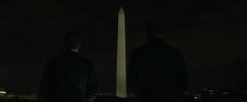 Movie still from “Without Remorse” (2021), directed by Stefano Sollima – Two men are standing in front of the washington monument at night; Medium shot, Low angle