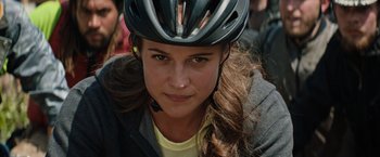Movie still from “Tomb Raider” (2018), directed by Roar Uthaug – A person wearing a bike helmet; Close Up shot, Over the shoulder angle