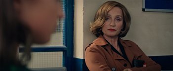 Movie still from “Tomb Raider” (2018), directed by Roar Uthaug – A woman in a brown jacket is sitting in front of a window; Close Up shot, Over the shoulder angle