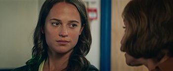 Movie still from “Tomb Raider” (2018), directed by Roar Uthaug – A person looking at the camera; Close Up shot, Over the shoulder angle