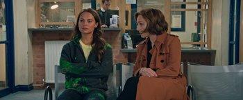 Movie still from “Tomb Raider” (2018), directed by Roar Uthaug – Two women sitting next to each other on a bench; Medium shot, Over the shoulder angle