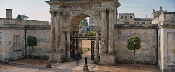 Movie still from “Tomb Raider” (2018), directed by Roar Uthaug – A woman walking through an archway in an old building; Extreme Wide shot, High angle