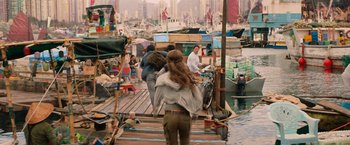 Movie still from “Tomb Raider” (2018), directed by Roar Uthaug – A group of people standing on top of a dock; Wide shot, Over the shoulder angle