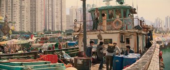 Movie still from “Tomb Raider” (2018), directed by Roar Uthaug – A group of people standing on the side of a boat; Wide shot, High angle