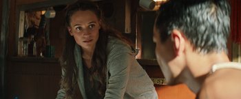 Movie still from “Tomb Raider” (2018), directed by Roar Uthaug – A woman looking into a mirror while standing next to a man; Close Up shot, Over the shoulder angle