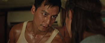 Movie still from “Tomb Raider” (2018), directed by Roar Uthaug – A person wearing a tank top; Close Up shot, Over the shoulder angle