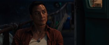 Movie still from “Tomb Raider” (2018), directed by Roar Uthaug – A person wearing a necklace; Close Up shot, Over the shoulder angle