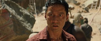 Movie still from “Tomb Raider” (2018), directed by Roar Uthaug – A person wearing a brown shirt; Close Up shot, Over the shoulder angle