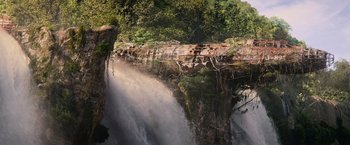 Movie still from “Tomb Raider” (2018), directed by Roar Uthaug – A view of a waterfall from the side of a cliff; Extreme Wide shot, Overhead angle