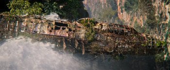 Movie still from “Tomb Raider” (2018), directed by Roar Uthaug – An old train is on the tracks near a waterfall; Extreme Wide shot, High angle