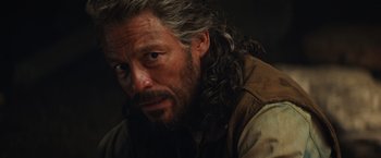 Movie still from “Tomb Raider” (2018), directed by Roar Uthaug – A person with long grey hair; Close Up shot, Over the shoulder angle