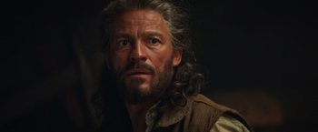 Movie still from “Tomb Raider” (2018), directed by Roar Uthaug – A person with long grey hair; Close Up shot, Low angle