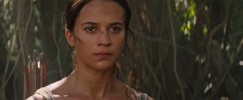 Movie still from “Tomb Raider” (2018), directed by Roar Uthaug – A person wearing a shirt; Close Up shot, Low angle