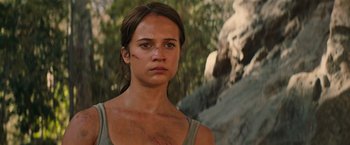 Movie still from “Tomb Raider” (2018), directed by Roar Uthaug – A person with a scar on their face; Close Up shot, Low angle