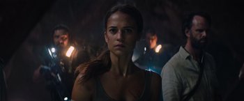 Movie still from “Tomb Raider” (2018), directed by Roar Uthaug – A person wearing a tank top; Close Up shot, Low angle