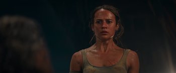 Movie still from “Tomb Raider” (2018), directed by Roar Uthaug – A person wearing a tank top; Close Up shot, Low angle