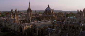 Movie still from “Tomorrow Never Dies” (1997), directed by Roger Spottiswoode – An aerial view of a city with a church in the background; Extreme Wide shot, High angle