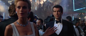 Movie still from “Tomorrow Never Dies” (1997), directed by Roger Spottiswoode – A group of people in formal wear at an event; Medium shot, Over the shoulder angle