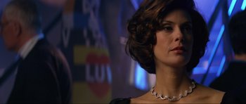 Movie still from “Tomorrow Never Dies” (1997), directed by Roger Spottiswoode – A person wearing a necklace; Close Up shot, Low angle