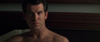 Movie still from “Tomorrow Never Dies” (1997), directed by Roger Spottiswoode – A person wearing a shirt; Close Up shot, Over the shoulder angle