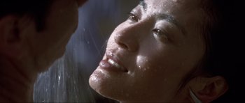 Movie still from “Tomorrow Never Dies” (1997), directed by Roger Spottiswoode – A person taking a shower; Extreme Close Up shot, Low angle