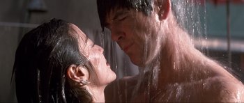 Movie still from “Tomorrow Never Dies” (1997), directed by Roger Spottiswoode – A man and a woman in the shower; Close Up shot, Low angle