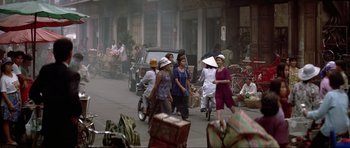 Movie still from “Tomorrow Never Dies” (1997), directed by Roger Spottiswoode – A group of people walking down a street; Extreme Wide shot, High angle