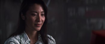 Movie still from “Tomorrow Never Dies” (1997), directed by Roger Spottiswoode – A person with long black hair; Close Up shot, Over the shoulder angle