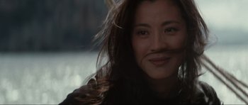 Movie still from “Tomorrow Never Dies” (1997), directed by Roger Spottiswoode – A person with long hair; Close Up shot, Over the shoulder angle