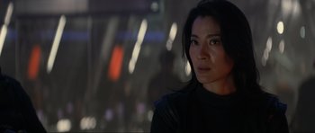 Movie still from “Tomorrow Never Dies” (1997), directed by Roger Spottiswoode – A person wearing a black jacket; Close Up shot, Over the shoulder angle