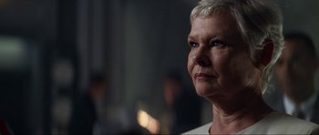 Movie still from “Tomorrow Never Dies” (1997), directed by Roger Spottiswoode – An older woman looking up at the sky; Close Up shot, Low angle