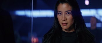 Movie still from “Tomorrow Never Dies” (1997), directed by Roger Spottiswoode – A person with long black hair; Close Up shot, Over the shoulder angle