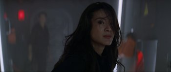 Movie still from “Tomorrow Never Dies” (1997), directed by Roger Spottiswoode – A person with long black hair; Close Up shot, Low angle