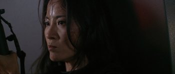 Movie still from “Tomorrow Never Dies” (1997), directed by Roger Spottiswoode – A person with long black hair; Close Up shot, Low angle