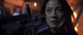 Movie still from “Tomorrow Never Dies” (1997), directed by Roger Spottiswoode – A person holding a gun; Close Up shot, Low angle