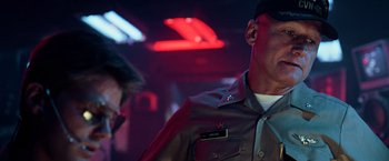 Movie still from “Top Gun” (1986), directed by Tony Scott – A person wearing a military uniform; Close Up shot, Low angle