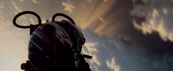 Movie still from “Top Gun” (1986), directed by Tony Scott – A backpack is shown against a cloudy sky; Close Up shot, Low angle