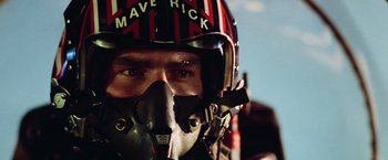 Movie still from “Top Gun” (1986), directed by Tony Scott – A person wearing a helmet; Close Up shot, Low angle