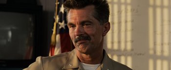 Movie still from “Top Gun” (1986), directed by Tony Scott – A person wearing a uniform; Close Up shot, Low angle