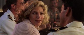 Movie still from “Top Gun” (1986), directed by Tony Scott – A person sitting at a table; Close Up shot, Over the shoulder angle