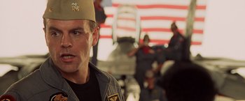 Movie still from “Top Gun” (1986), directed by Tony Scott – A person wearing a hat; Close Up shot, Low angle
