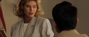 Movie still from “Top Gun” (1986), directed by Tony Scott – A woman in a white jacket looking at a man in a white jacket; Close Up shot, Over the shoulder angle