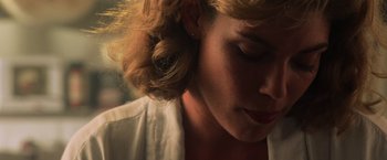 Movie still from “Top Gun” (1986), directed by Tony Scott – A woman's face in a white shirt; Close Up shot, Low angle